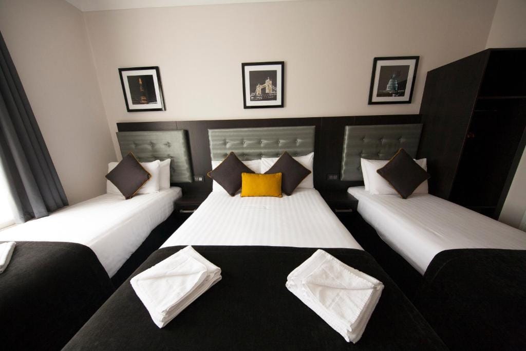 A quadruple room with one double bed between two single beds