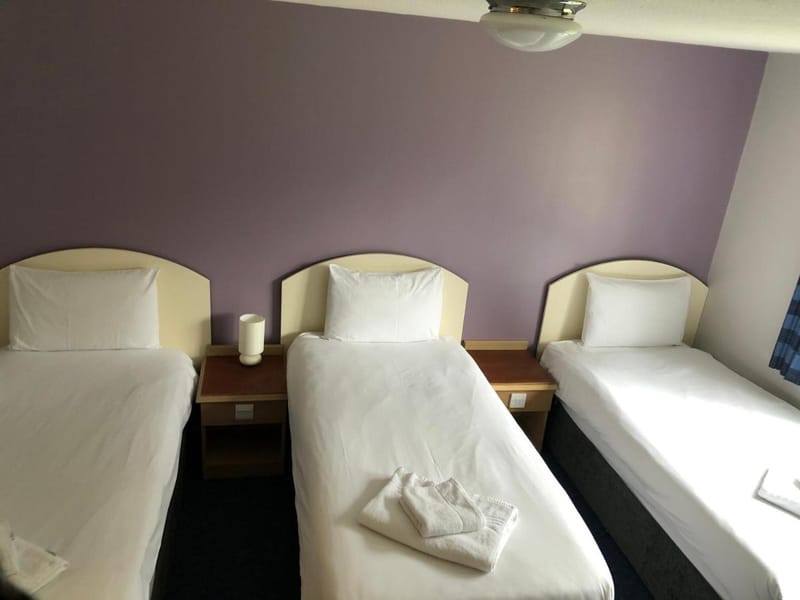 Three single beds in the Triple Room