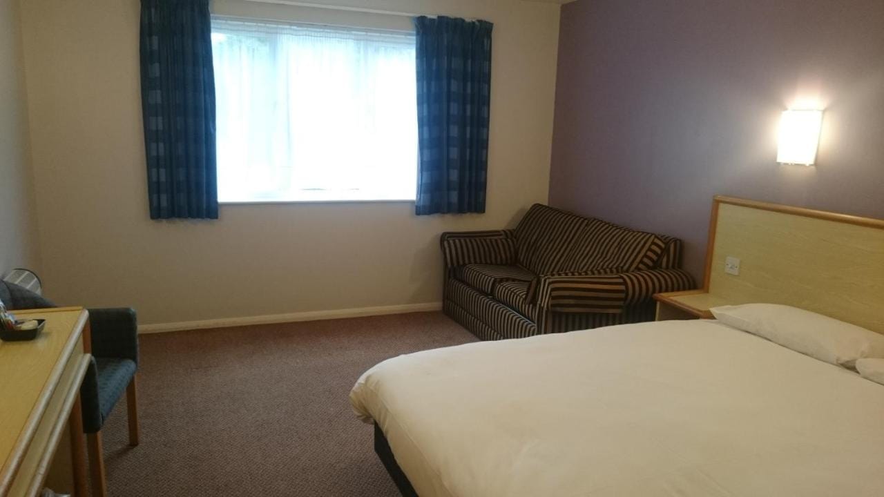 Bedroom with a bed and a sofa