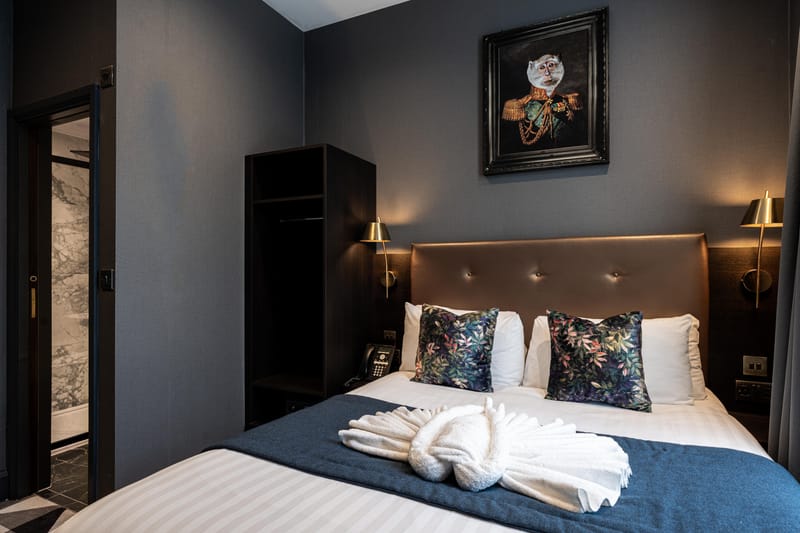 A double room with the marble bathroom beyond the open door