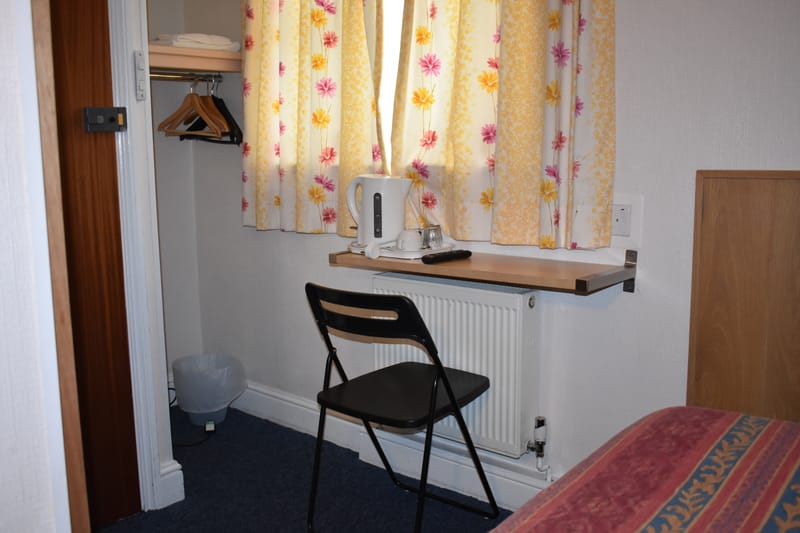 Single room with its own bathroom — window and chair