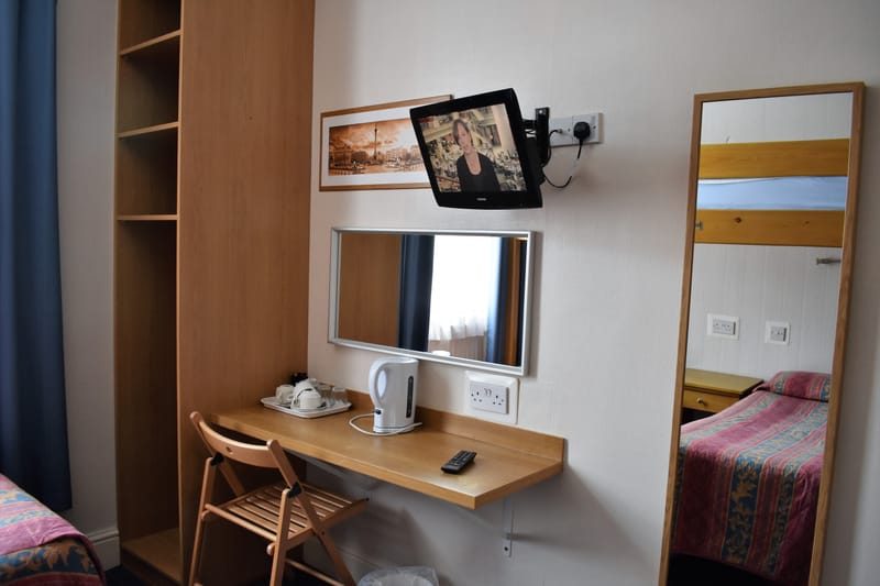 Triple room with its own bathroom — desk, mirror and television