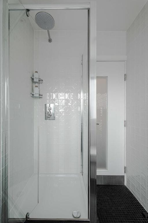 The glass walk-in shower serving a Luxury Twin Room