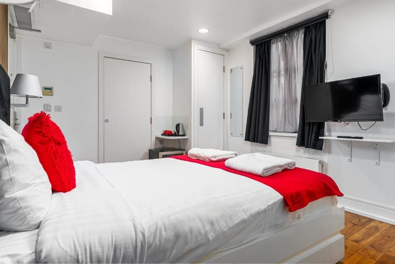 The double bed and television in a Standard Double Room