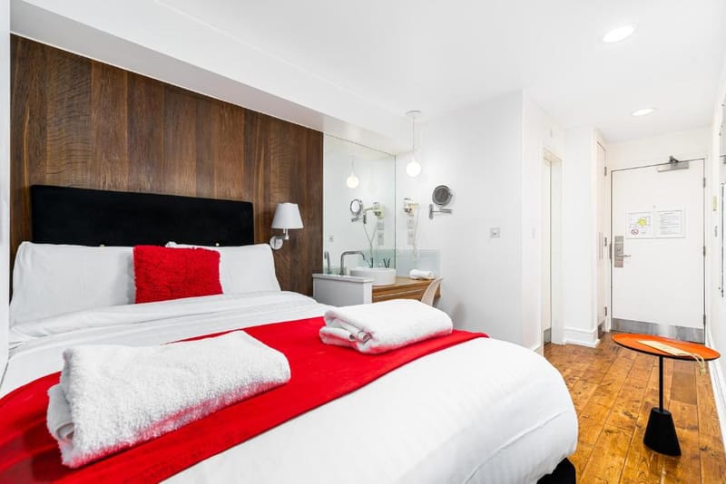 The double bed and ensuite door in a Superior Double Room