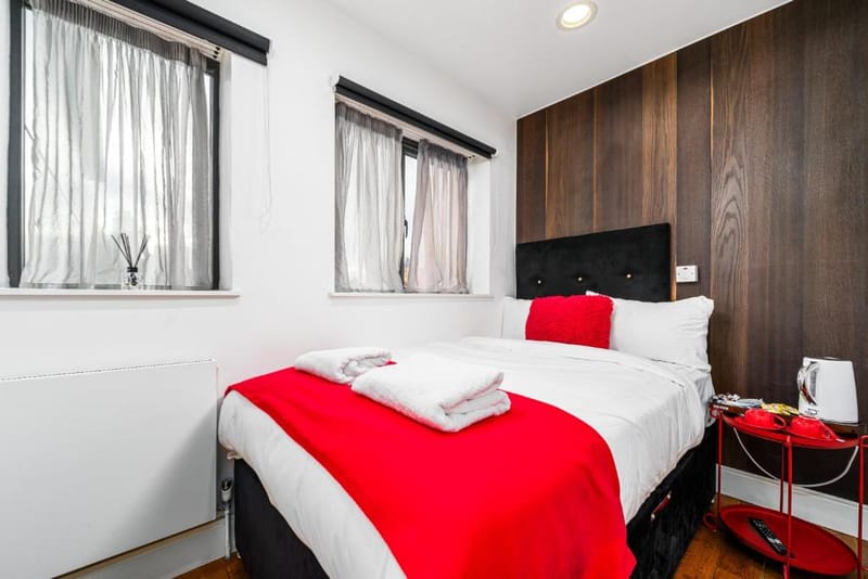 A Standard Double Room's double bed against walnut panelling