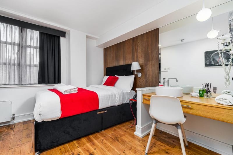 A Small Double Room with its double bed and writing desk