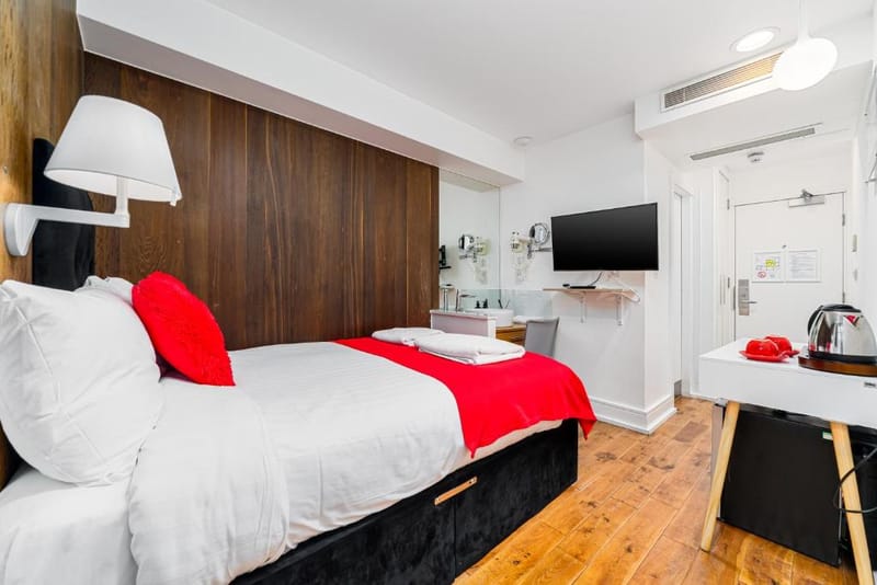 The double bed and walnut panelling in a Small Double Room