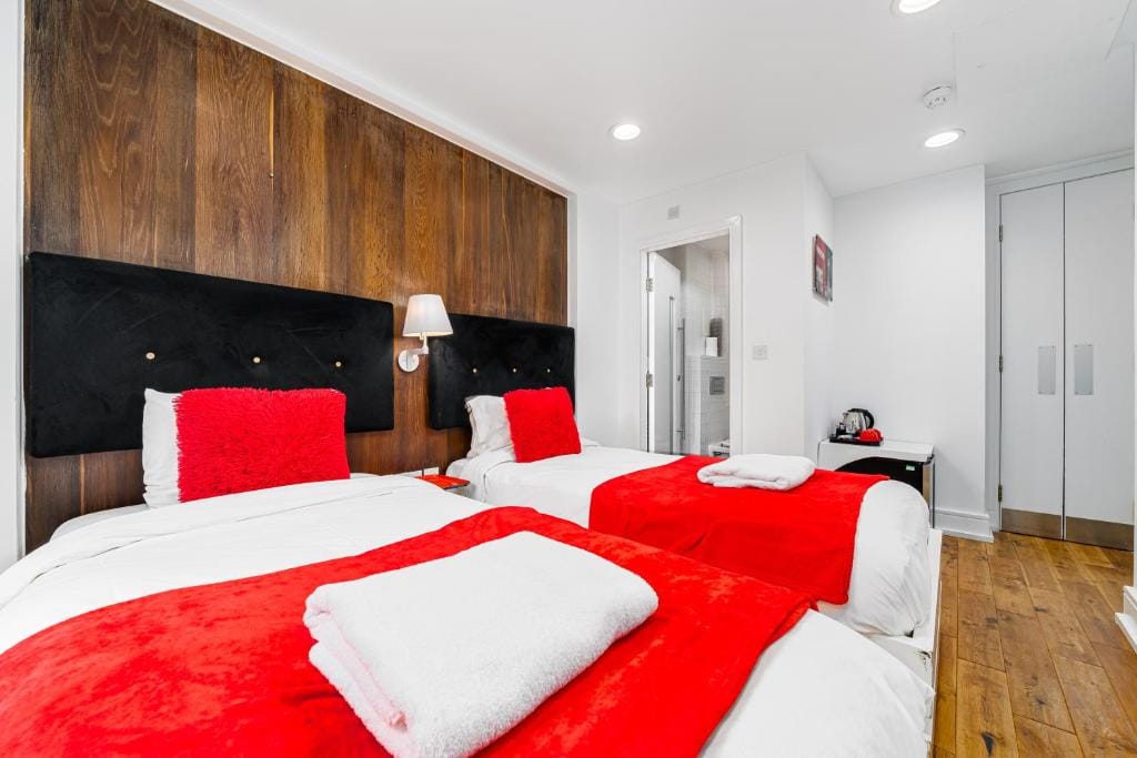 A Luxury Twin Room, with two single beds against walnut panelling