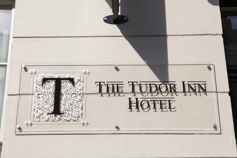 The Tudor Inn Hotel name plate on Warwick Way