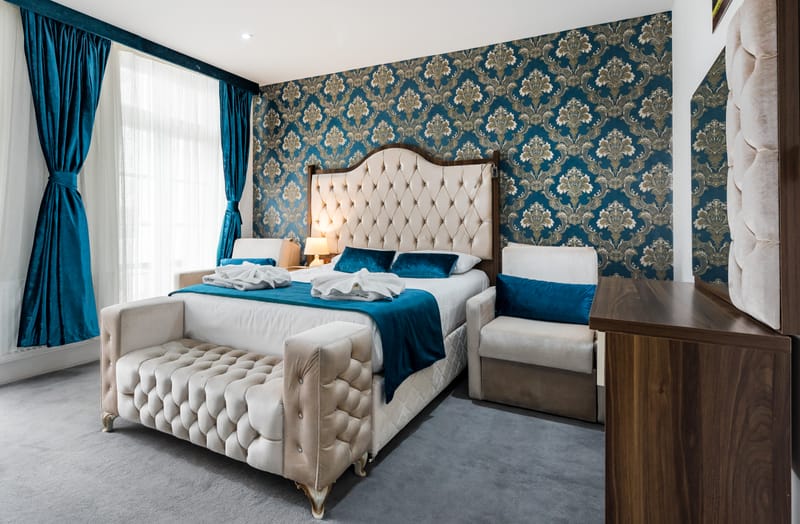The Family Room's damask feature wall, double bed and day bed