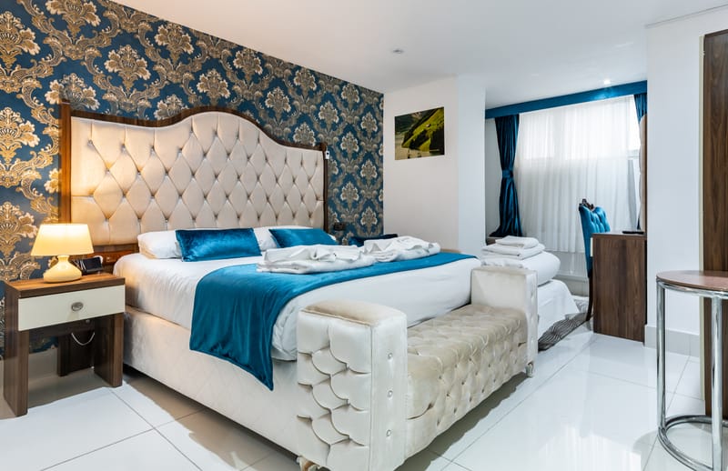 The beds against the damask feature wall in a Triple Room